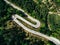 Aerial above view of a rural mountain landscape with a curvy road in Italy