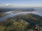 Aerial above a winding river in a wetland at sunrise