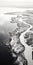 Aerial Abstractions: Serene Black And White River Running Along The Coast