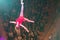 Aerial acrobats perform in circus.