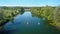 AERIAL: Active young travelers go on a fun canoe trip down the scenic river.