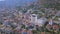 Aerial of the Alanya city located in Turkey on the green mountain slope, summer resort. Art, Flying above the hills with