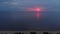Aerial Amazing dark scenic vivid crimson rare red sunset with violet and magenta colors at the Baltic Sea with small sun