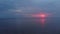 Aerial Amazing dark scenic vivid crimson rare red sunset with violet and magenta colors at the Baltic Sea with small sun