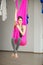 Aerial antigravity yoga concept, relaxed smiling girl in hammock