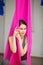 Aerial antigravity yoga concept, relaxed smiling girl in hammock