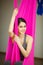 Aerial antigravity yoga concept, relaxed smiling girl in hammock