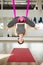 Aerial antigravity yoga. Girl in upside down lotus pose