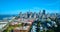 Aerial apartment buildings leading to heart of downtown skyscrapers with view of Oakland Bay Bridge