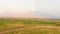 Aerial approach view mountain misty Ararat panorama with colorful agricultural fields