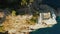 Aerial approaching view from above of a lighthouse in Portofino, Italy. A lighthouse is on a rocky hill surrounded by