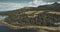 Aerial Arran island bay landscape zooming view: forests, meadows, mountains at autumn day