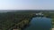 Aerial: artificial lakes, quarries with water and green forest. land reclamation