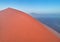 Aerial, artistic photo of dune with climber on its edge. Early morning Namib desert covered in mist. Orange dunes of Namib from