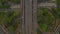 Aerial ascending birds eye close up overhead top down view of multiple vehicles on a multi lane road intersection on a