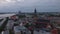 Aerial ascending footage of Riga Cathedral and historic buildings in old town after sunset. Riga, Latvia