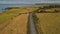 Aerial autumn road: car travel view. Beautiful Northern Ireland countryside nature scene