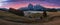 Aerial autumn sunrise scenery with yellow larches and small alpine building and Odle - Geisler mountain group on background.