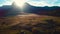 Aerial autumn sunrise scenery with yellow larches, small village and Odle - Geisler mountain group on background. Alpe di Siusi S