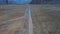 Aerial backward moving shot of a himalayan road in spiti valley , himachal pradesh, Car at a distance