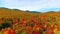 Aerial backwards across stunning Vermont peak fall hills and mountains