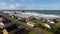 Aerial backwards dolly Bandon Beach Face Rock Beach with homes on bluff