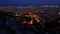 Aerial Barcelona night panorama, people sitting on top Bunker Del Carmel, timelapse