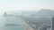 AERIAL: Barcelona, Spain Wide Drone Shot of City and Ocean with Boats in the Bay