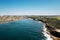 Aerial of a beautiful beach in the south of Sydney with a distant cityscape in the background