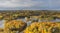 Aerial of the beautiful lake surrounded by the colorful forest on a gloomy autumn day in Estonia