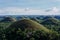 Aerial beautiful landscape of Chocolate Hills in Cebu Philippines under a blue sky