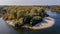 Aerial beautiful landscape drone shot of kayak at curved river near town