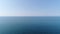 Aerial: beautiful sea background. Calm blue sea, horizon, clear sky, seascape.