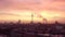 AERIAL: Beautiful View of Berlin TV Tower Alexanderplatz with with smoke on rooftops at Sunrise in Red morning light