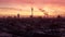 AERIAL: Beautiful View of Berlin TV Tower Alexanderplatz with with smoke on rooftops at Sunrise in Red morning light