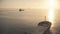 Aerial big cargo ship sailing orange sunset sun. Low flight over empty vessel cruising deep open sea