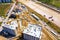 Aerial Bird Eye View Of a Construction Site Building Cranes Looking Down Industrial Machinery Area around Residential Urban