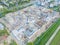 Aerial Bird Eye View Of a Construction Site Building Cranes Looking Down Industrial Machinery Area around Residential Urban