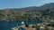 Aerial bird`s eye view video taken by drone of beautiful picturesque houses with views to port of Symi island