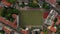 Aerial birds eye overhead top down view from ascending drone. Rocket shot of football playground closely surrounded by