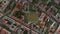 Aerial birds eye overhead top down view of urban neighbourhood with football playground. Ascending shot of streets with