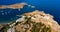 Aerial birds eye view drone photo of village Lindos, Rhodes island, Dodecanese, Greece. Sunset panorama with castle