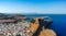 Aerial birds eye view drone photo of village Lindos, Rhodes island, Dodecanese, Greece. Sunset panorama with castle, Mediterranean