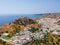 Aerial birds eye view drone photo of village Lindos, Rhodes island, Dodecanese, Greece. Sunset panorama with castle, Mediterranean