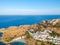 Aerial birds eye view drone photo of village Lindos, Rhodes island, Dodecanese, Greece. Sunset panorama with castle, Mediterranean