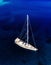 Aerial birds eye view from drone of yacht in deep blue sea