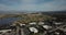 Aerial birds eye view of shoreline lake Google campus amphitheater park mountain background move forward