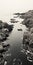 Aerial Black And White Photograph Of Rocky Shore And Sea