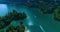 Aerial: Boats sail towards each other along the lake among the mountains.