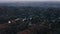 AERIAL: Breathtaking Tilt up over Hollywood Sign Letter from back revealing Los Angeles Cityscape in Beautiful Sunset